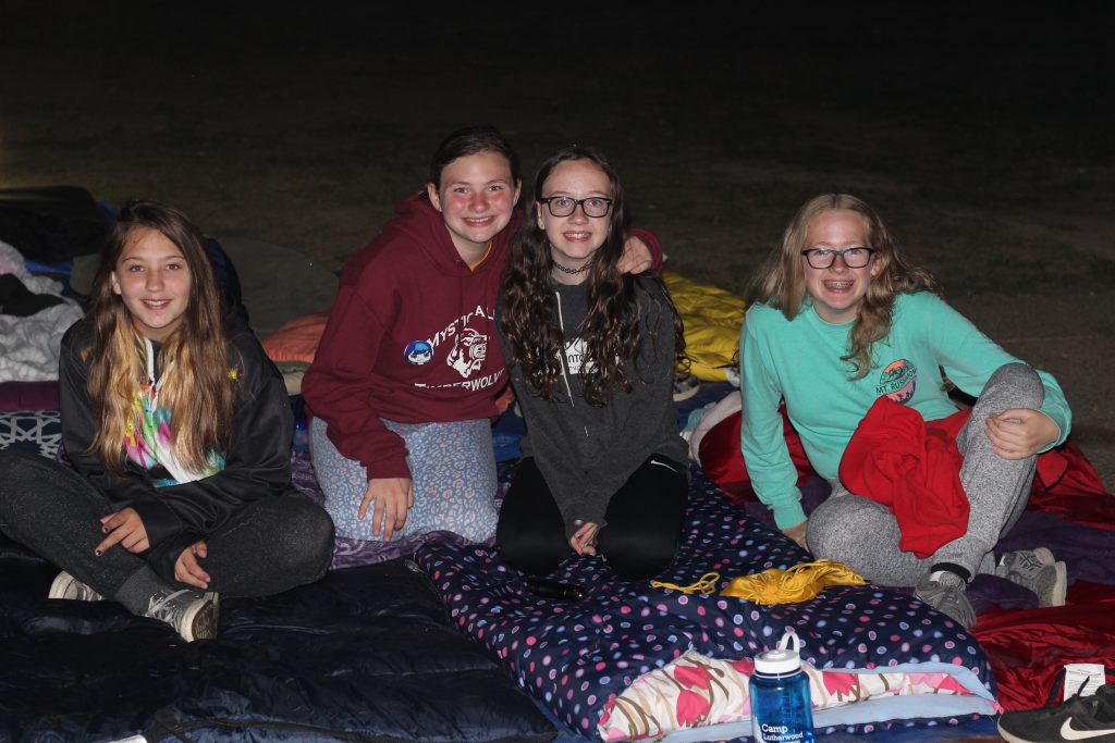 Older elementary-age campers getting ready to sleep outside at Camp Lutherwood Oregon