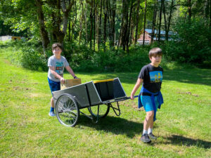 Two boys hauling supplies at work day