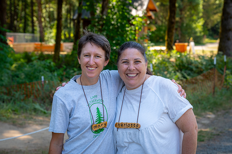 Former staff members with their arms around each other