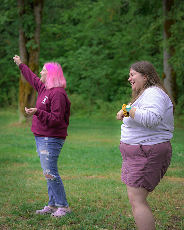 Staff members leading songs and laughing