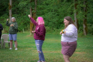 Staff members leading songs and laughing